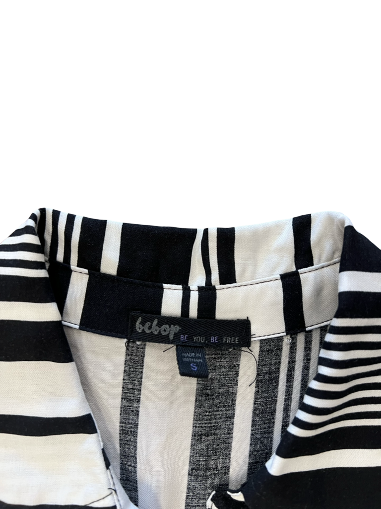 Black and white striped shirt with a brand label on a white background