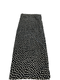 Black skirt with white polka dot pattern on a white background
