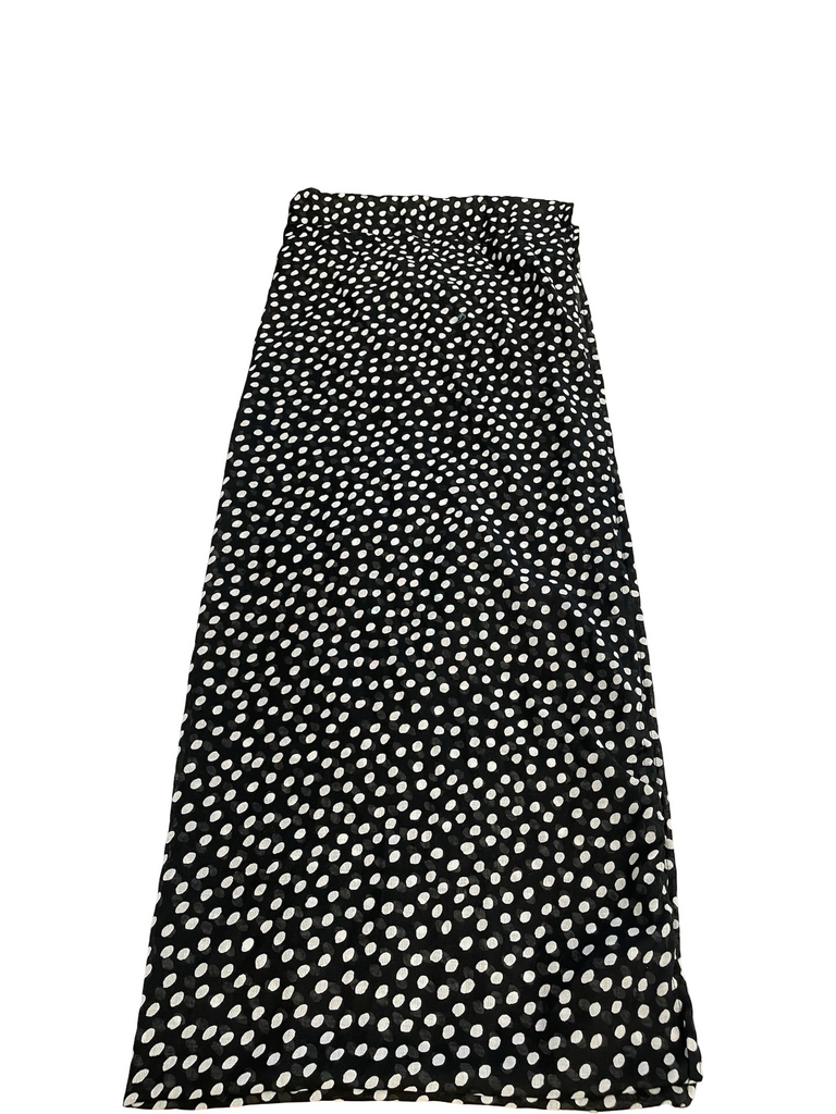 Black skirt with white polka dot pattern on a white background
